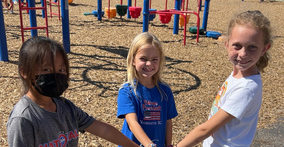 Three Washington students on the playground