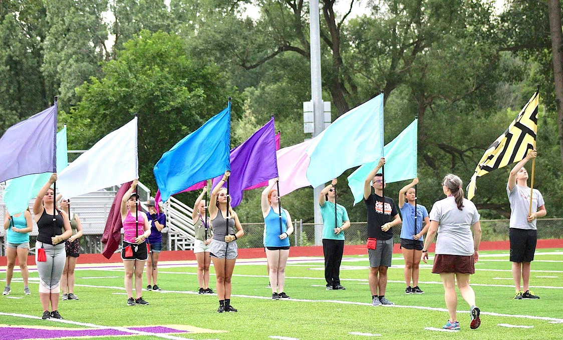 Students with flags practicing