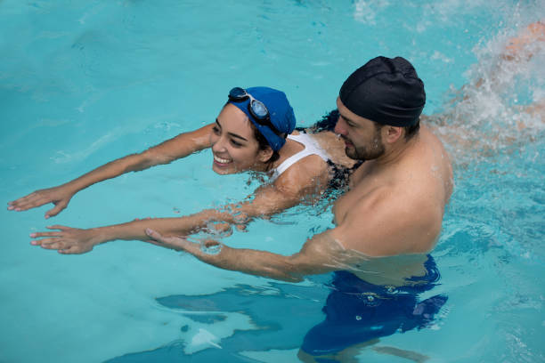 An image of an adult learning to swim.