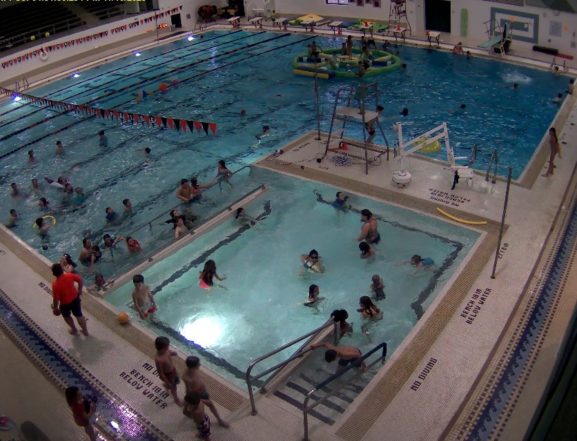 An image of our main pool with many swimmers and the wibit in the water.